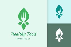 logo d'aliments sains avec forme de fourchette et de feuille vecteur