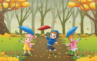 dessin animé enfants tenant un parapluie à l'automne