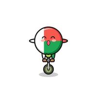 le mignon personnage du drapeau de madagascar fait du vélo de cirque vecteur