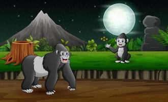 une mère gorille avec son bébé dans le paysage nocturne vecteur