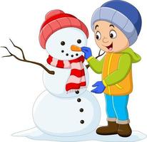 dessin animé petit garçon construisant un bonhomme de neige vecteur