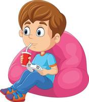 dessin animé petit garçon jouant au jeu vidéo tout en buvant un soda vecteur