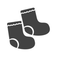 icône noire de glyphe de chaussettes de bébé vecteur
