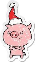 dessin animé autocollant en détresse heureux d'un cochon portant un bonnet de noel vecteur