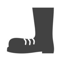icône noire de glyphe de bottes de construction vecteur