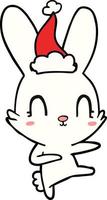joli dessin au trait d'un lapin dansant portant un bonnet de noel vecteur