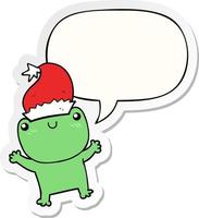 grenouille de dessin animé mignon portant un chapeau de noël et un autocollant de bulle de dialogue vecteur