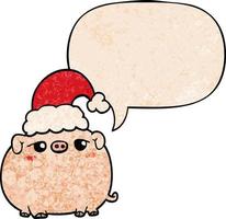 cochon de dessin animé portant un chapeau de noël et une bulle de dialogue dans un style de texture rétro vecteur