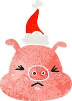 dessin animé rétro d'un visage de cochon en colère portant un bonnet de noel vecteur