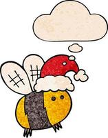 abeille de dessin animé mignon portant un chapeau de noël et une bulle de pensée dans un style de motif de texture grunge vecteur