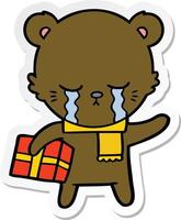 autocollant d'un ours de dessin animé qui pleure avec un cadeau vecteur