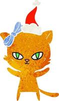 dessin animé rétro mignon d'un chat portant un bonnet de noel vecteur