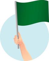 drapeau vert dans l'icône de la main vecteur