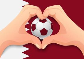 ballon de football qatar et forme de coeur à la main vecteur