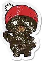 autocollant rétro en détresse d'un dessin animé agitant un ours en peluche noir en chapeau d'hiver vecteur