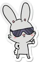 autocollant d'un lapin de dessin animé mignon portant des lunettes de soleil vecteur