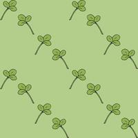 modèle sans couture avec des feuilles de trèfle sur fond vert clair. image vectorielle. vecteur