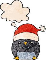 pingouin de dessin animé mignon portant un chapeau de noël et une bulle de pensée dans un style de motif de texture grunge vecteur