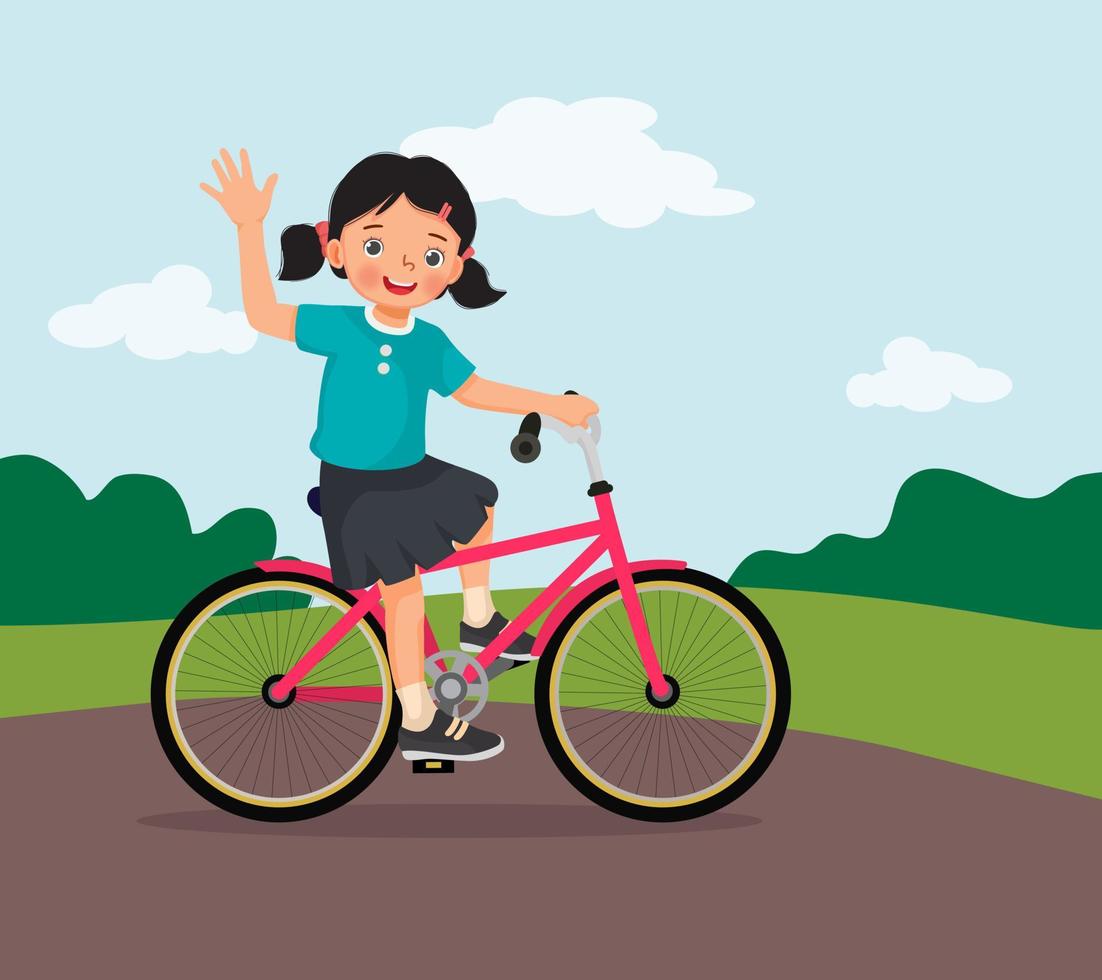 menina feliz andando de bicicleta se divertindo no parque em dia ensolarado acenando com a mão vetor