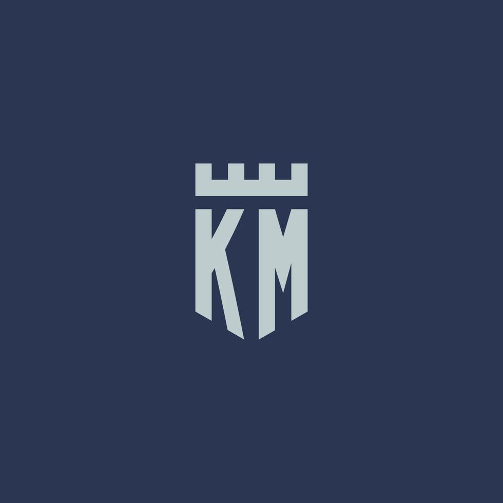 km logotipo monograma com castelo fortaleza e design de estilo escudo vetor