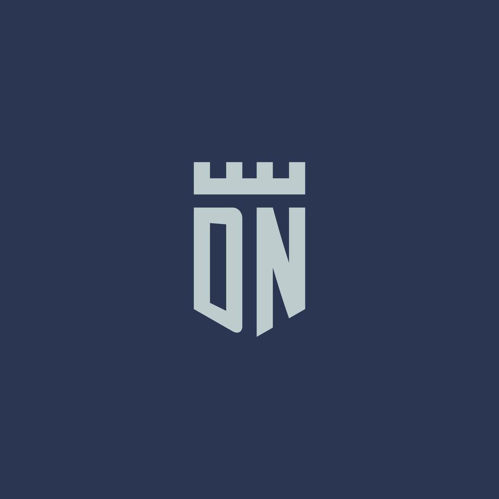 dn logotipo monograma com castelo fortaleza e design de estilo escudo vetor