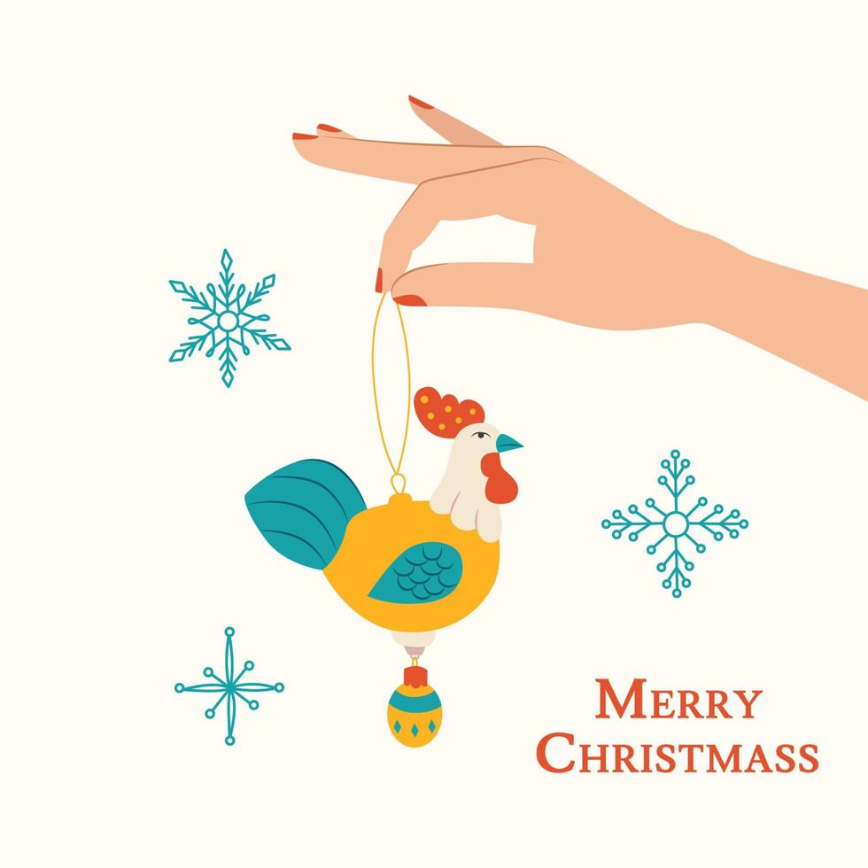 mão de mulher com brinquedo de ano novo de galo e flocos de neve. ilustração vetorial de brinquedo de natal para design de cartão vetor