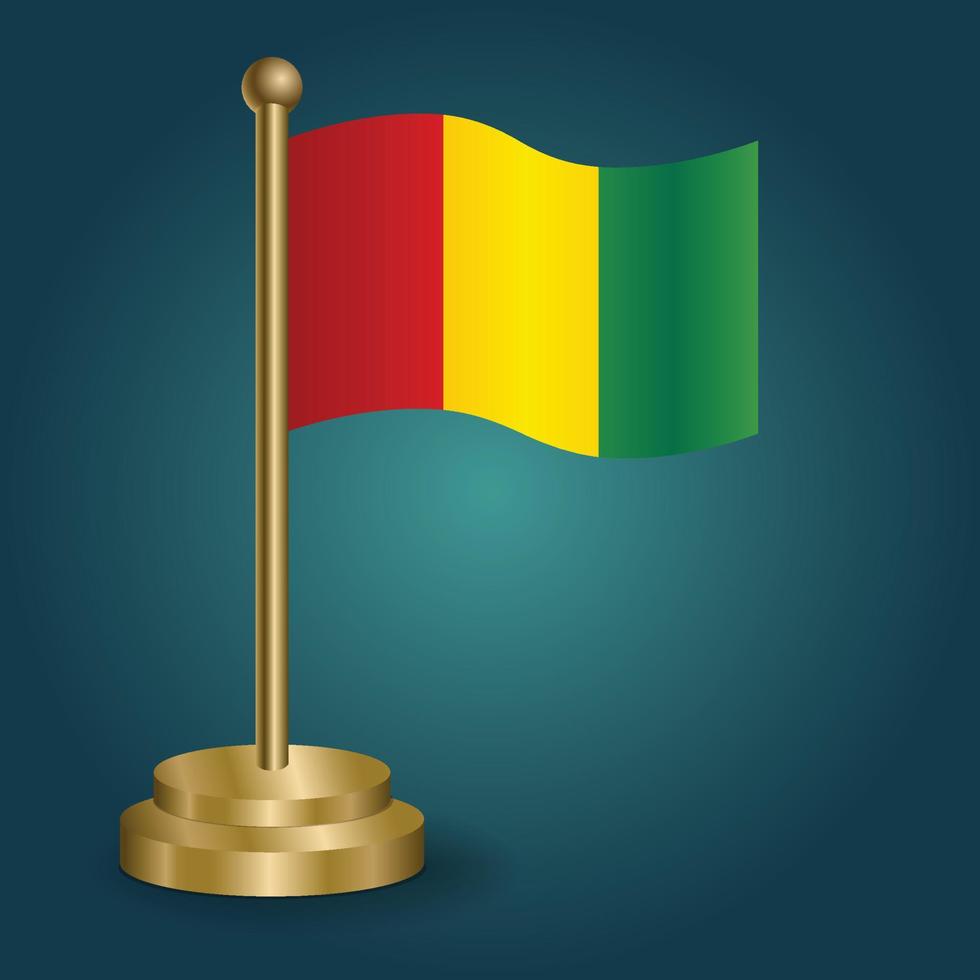 bandeira nacional da guiné no poste dourado em fundo escuro de gradação isolado. bandeira de mesa, ilustração vetorial vetor