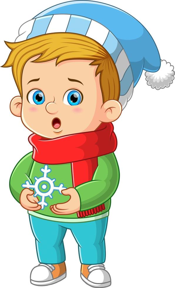 o menino bonito está segurando os flocos de neve e mostrando a expressão animada vetor