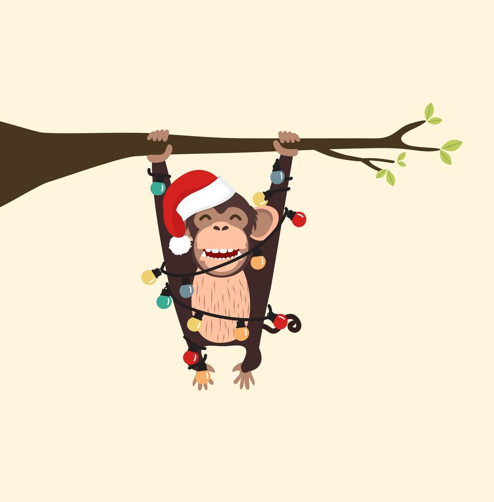 macaco com chapéu de natal escalando um galho de árvore vetor