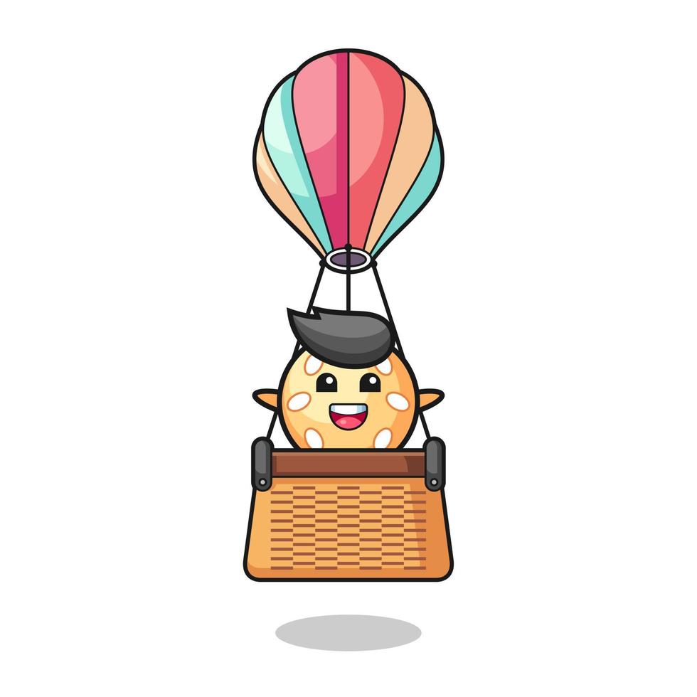 mascote da bola de gergelim em um balão de ar quente vetor