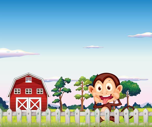 Um macaco perto do barnhouse vermelho vetor