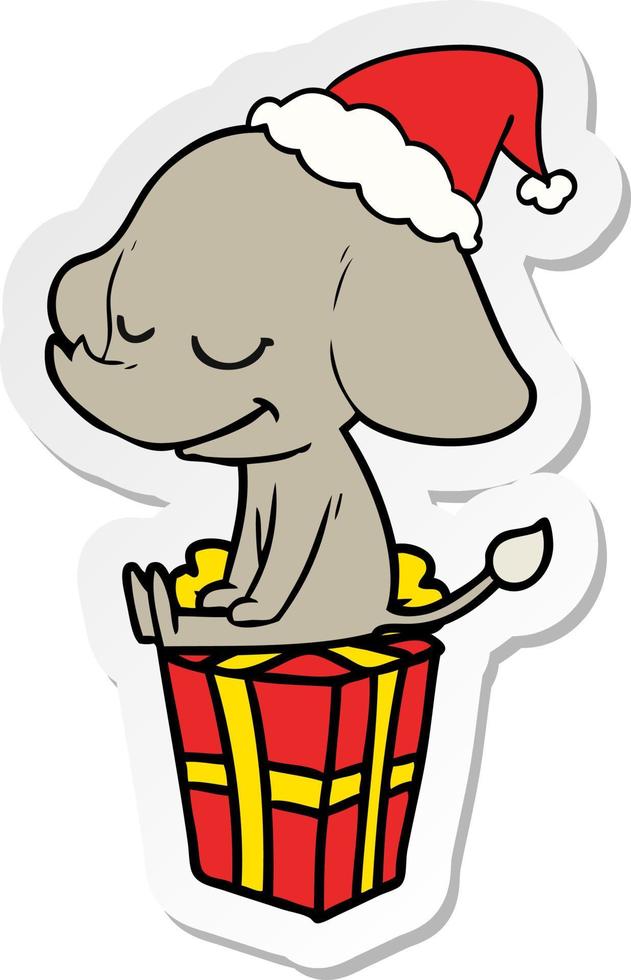 desenho de adesivo de um elefante sorridente usando chapéu de papai noel vetor