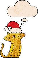 gato bonito dos desenhos animados usando chapéu de natal e balão de pensamento no estilo de padrão de textura grunge vetor