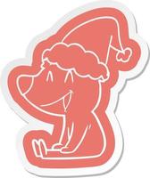 adesivo de desenho animado de urso sentado de um chapéu de papai noel vetor