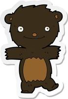 adesivo de um filhote de urso preto de desenho animado vetor