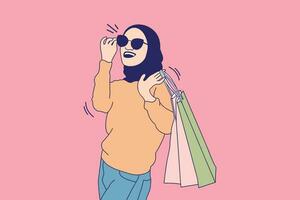 ilustrações de belas mulheres muçulmanas com óculos segurando sacolas de compras vetor