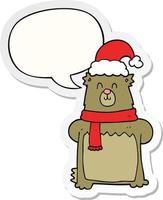 urso de desenho animado usando chapéu de natal e adesivo de bolha de fala vetor