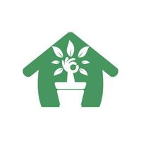 design de logotipo de vetor em casa jardim ecológico. árvore de mão com design de ícone de vaso de flores.