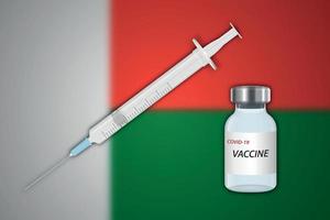 seringa e frasco de vacina em desfoque de fundo com bandeira de madagascar vetor