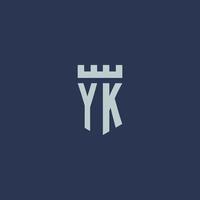 monograma do logotipo yk com castelo fortaleza e design de estilo escudo vetor