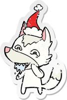 desenho de adesivo angustiado de um lobo faminto usando chapéu de papai noel vetor