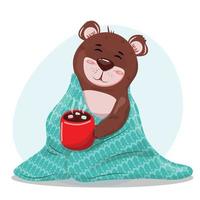 lindo ursinho de pelúcia com um chocolate quente no cobertor quente. vetor