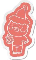adesivo de desenho animado de um homem barbudo com prancheta e caneta usando chapéu de papai noel vetor