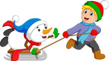 um menino animado está puxando seu boneco de neve no carrinho de gelo vetor