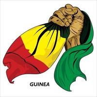 mão em punho segurando a bandeira da Guiné. ilustração em vetor de mão levantada agarrando a bandeira. bandeira drapejando ao redor da mão. formato eps escalável