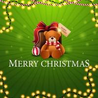 Feliz Natal, cartão quadrado verde com guirlandas e presente com ursinho de pelúcia vetor