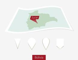 curvado papel mapa do Bolívia com capital sucre em cinzento fundo. quatro diferente mapa PIN definir. vetor