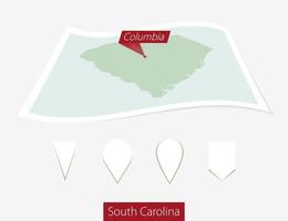curvado papel mapa do sul carolina Estado com capital Colômbia em cinzento fundo. quatro diferente mapa PIN definir. vetor