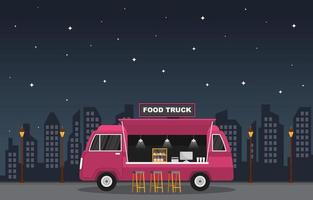 caminhão de comida estacionado na cidade à noite vetor