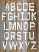 pintura de cor branca do alfabeto sobre fundo de cor retrô de madeira. ilustração vetorial. vetor